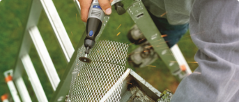 Person sawing through metal with a rotary tool