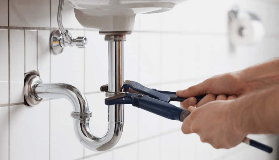 Man using wrench to tighten faucet