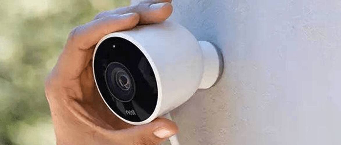 Person installing an outdoor security camera