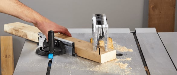 Table saw cutting through wood. 