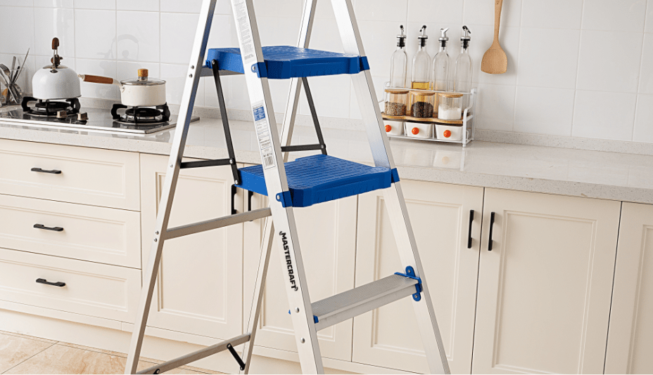 Two multi-task ladders linked with a metal work platform in a room where a woman pours paint into a tray on the floor. 