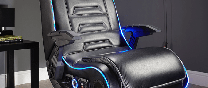 X Rocker EVO Pro 4.1 Pedestal Gaming Chair with glowing blue accent piping in a media room.
