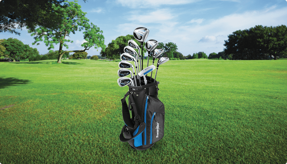 A complete set of silver golf clubs in a blue-and-black golf bag on a green golf course fairway.