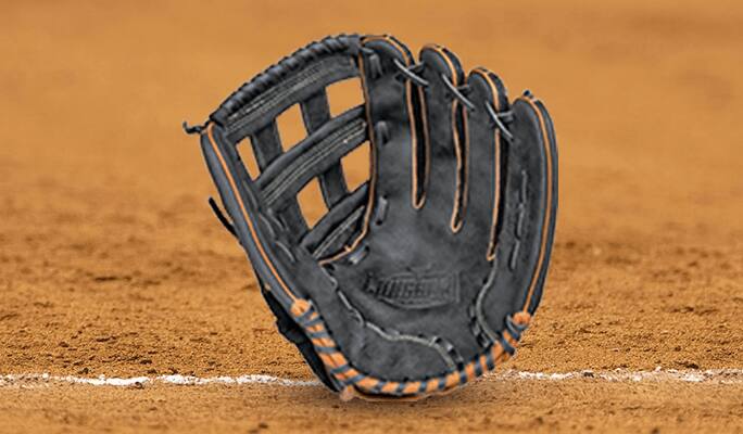 A black Rawlings Longhorn softball glove against a background of infield dirt.