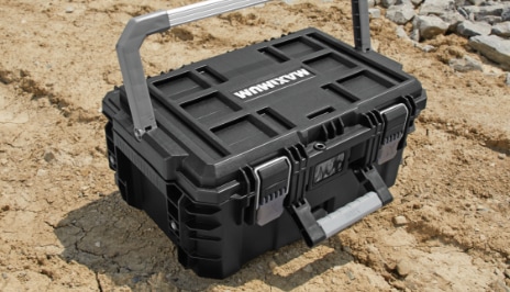 MAXIMUM BRIX modular toolbox, small sitting on dirt ground.