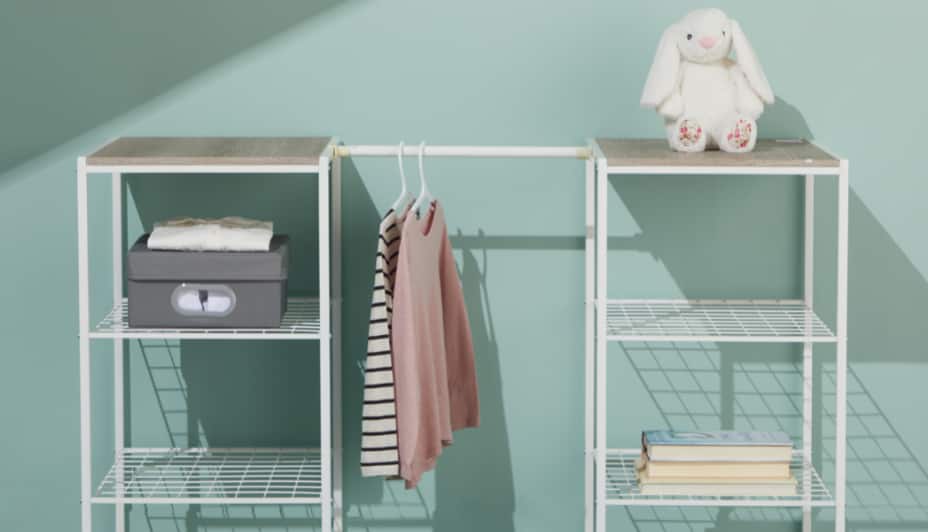 A closet organizer with clothes neatly and hanging from it.