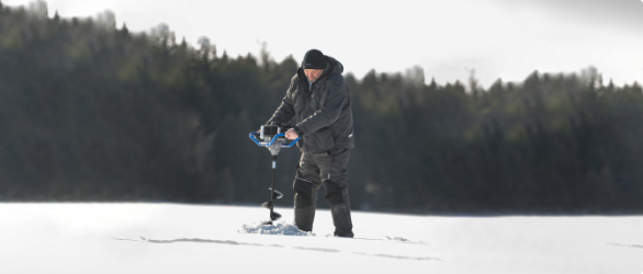 A man drilling into ice with auger. 