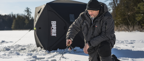  A man holding a fishing gear. 