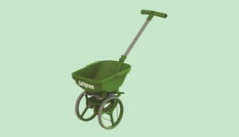 A single Golfgreen lawn spreader device against a light green background. 