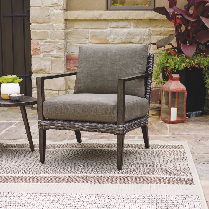 CANVAS Jensen Conversation Collection armchair in a beautiful patio.