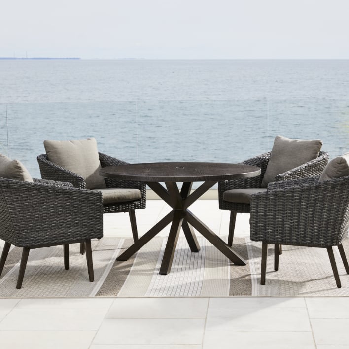  CANVAS Jensen Dining set kept in a patio overlooking a lake. 