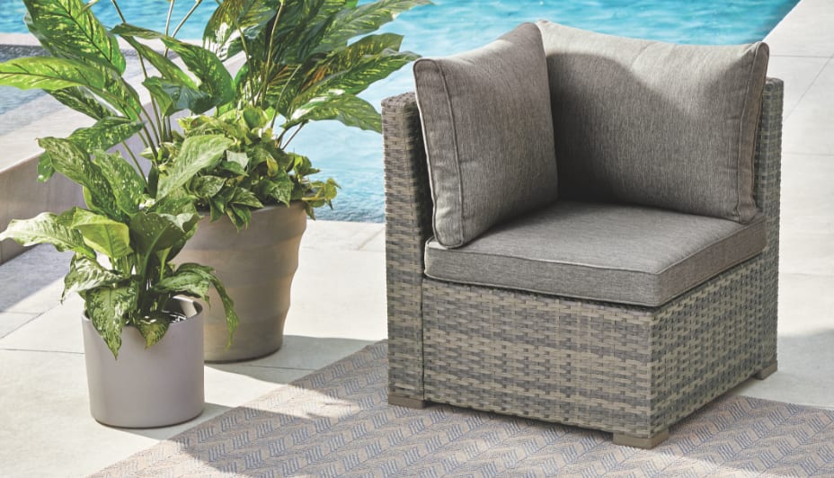 CANVAS Bala Corner Chair set by a pool  