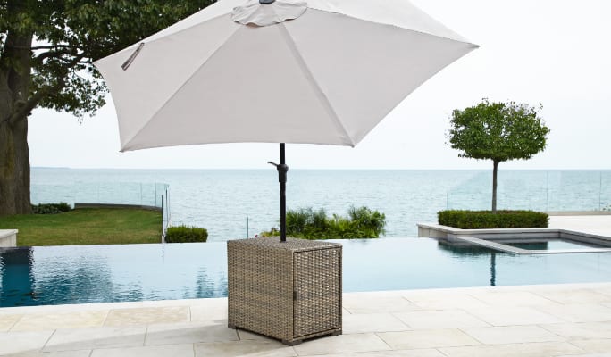 CANVAS Bala Patio Umbrella Table set outdoors by a pool  