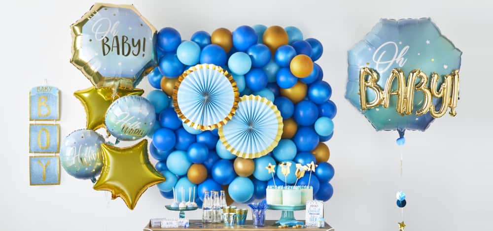 Blue balloons of different shapes and sizes along with other party décor.