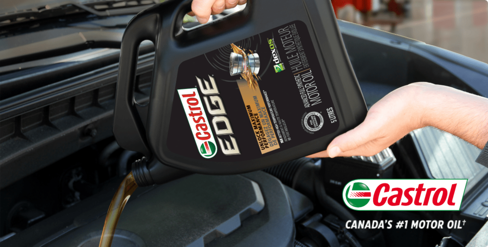 Castrol EDGE motor oil being poured into a motor reservoir.
