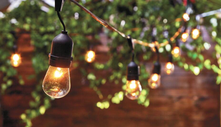 Outdoor patio space decorated with string lights and lanterns