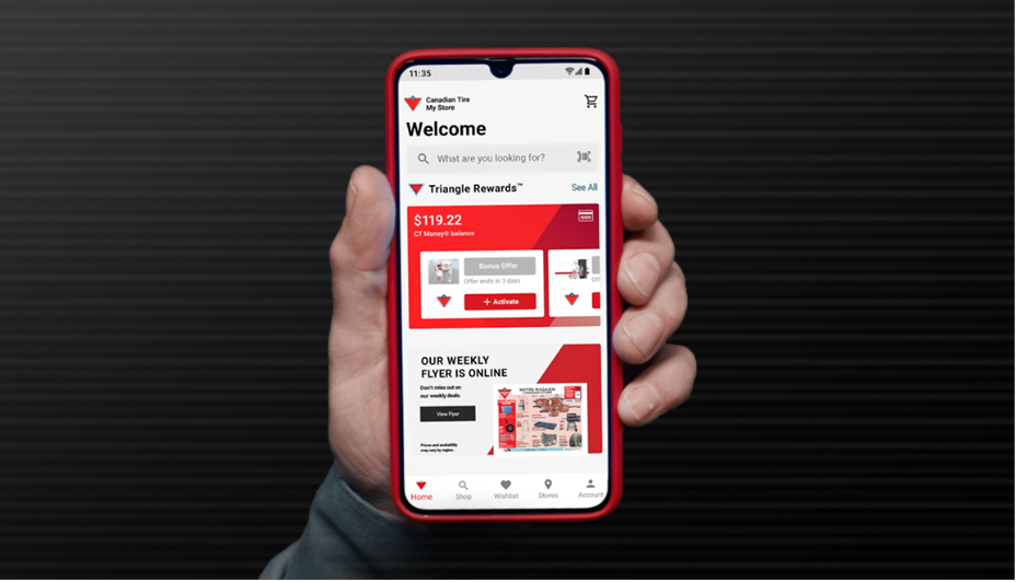 Man holding cellphone displaying the Canadian Tire App
