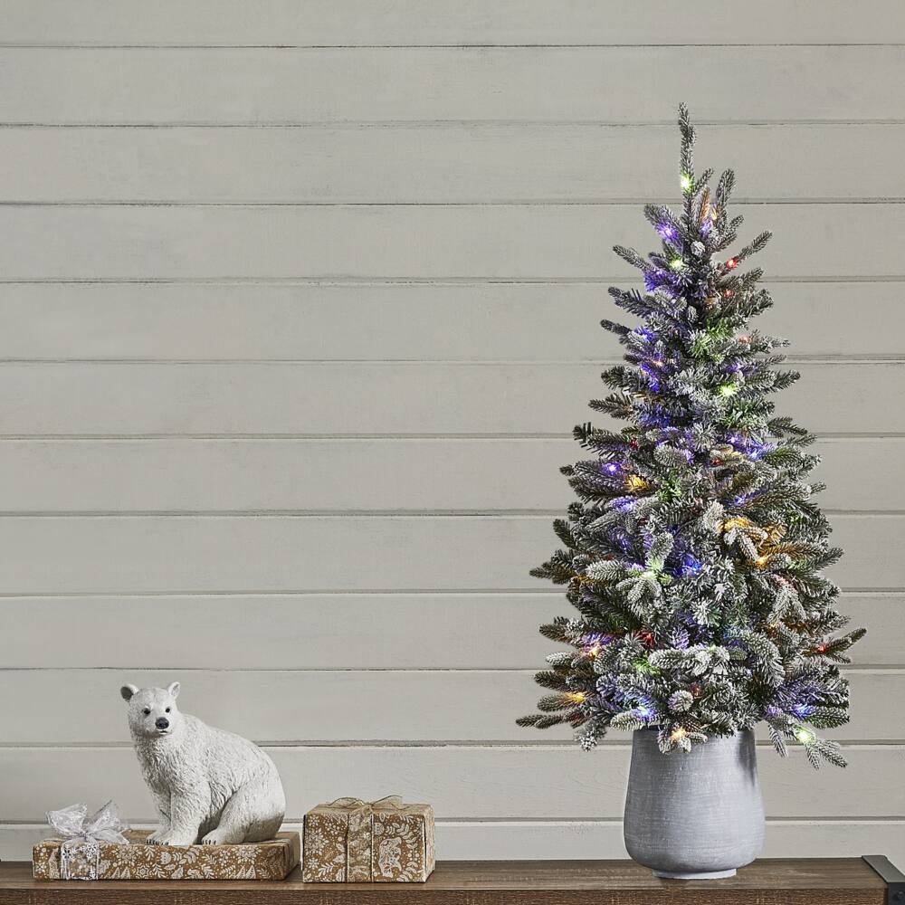 NOMA Halston 4-ft Pre-Lit Potted Tree next to a polar bear Christmas decoration.