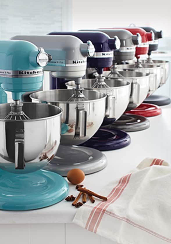 A row of KitchenAid stand mixers in a variety of colours.