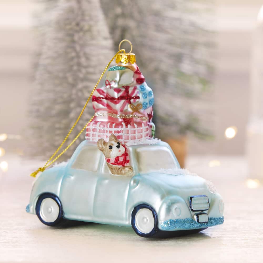 Jillian Harris & CANVAS Glass Car with Presents ornament displayed on a counter