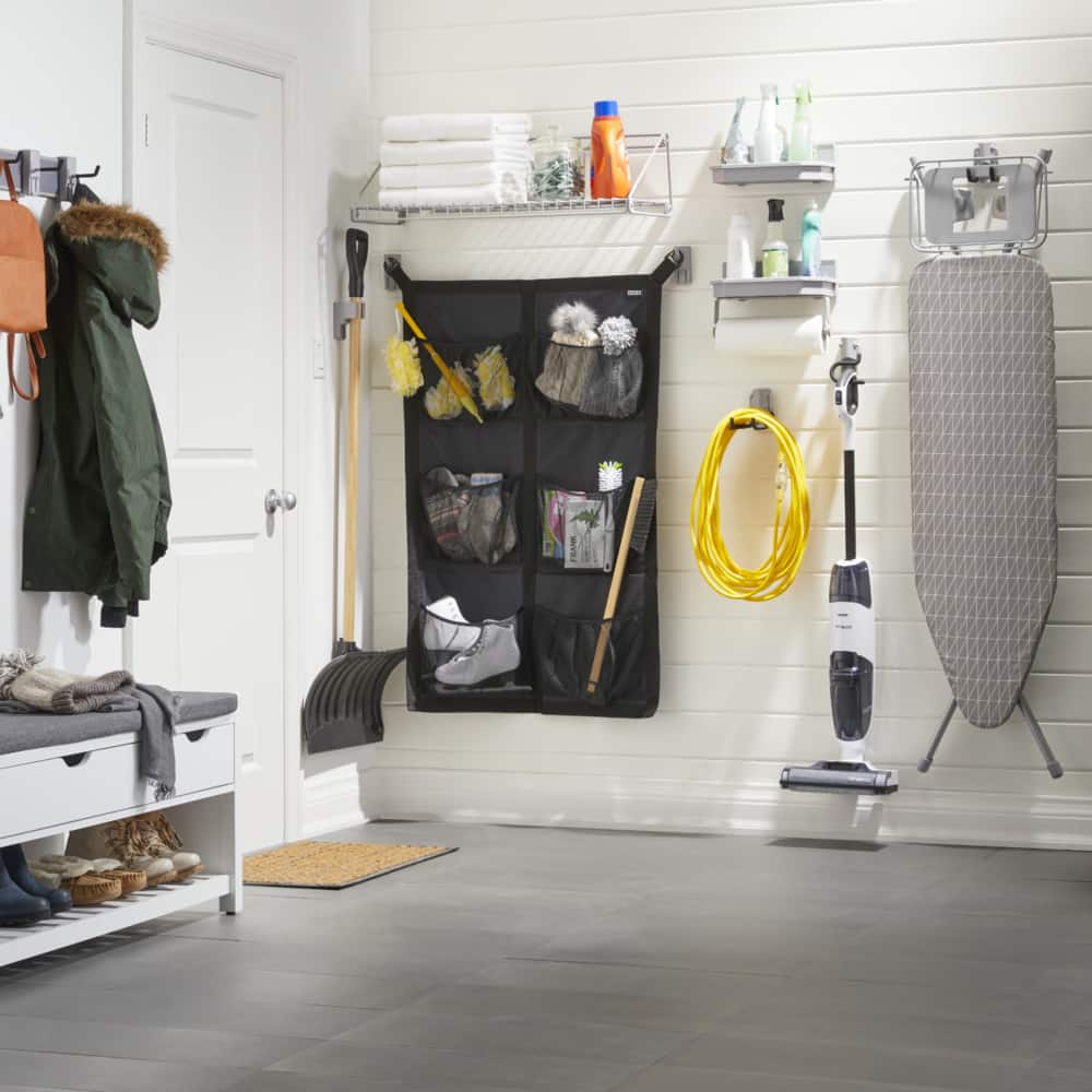 The MOD™ system in an entryway with net holder for accessories, racks for towels and cleaners, and clamp for a snow shovel.