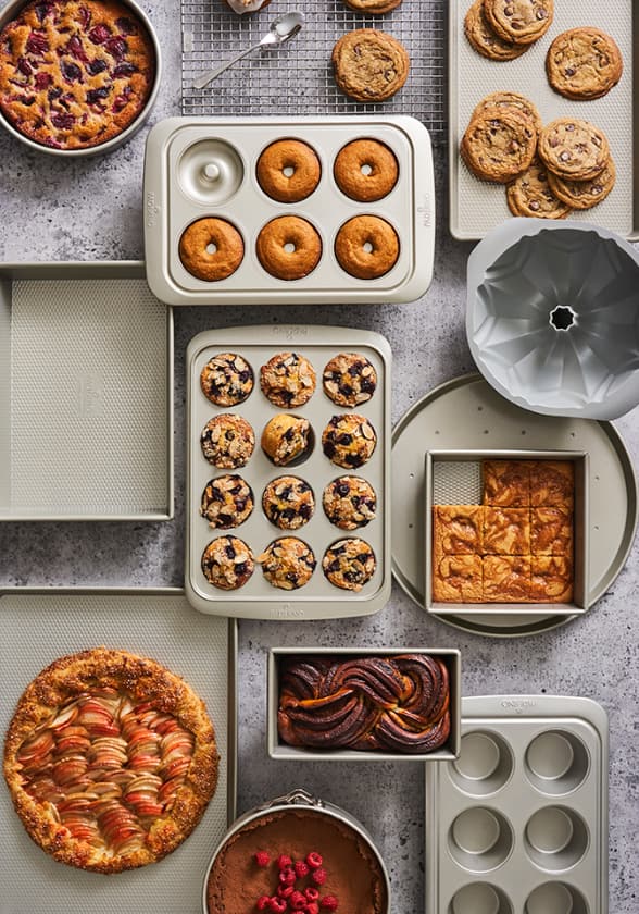 Freshly baked muffins and cookies on baking sheets.
