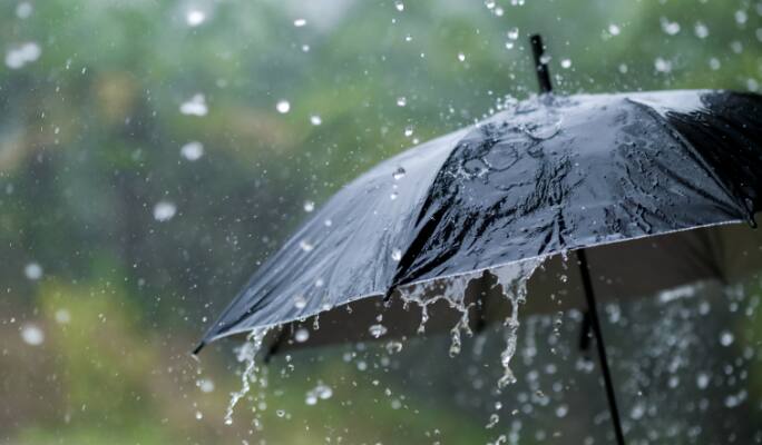 Closeup of an umbrella in rainy weather.