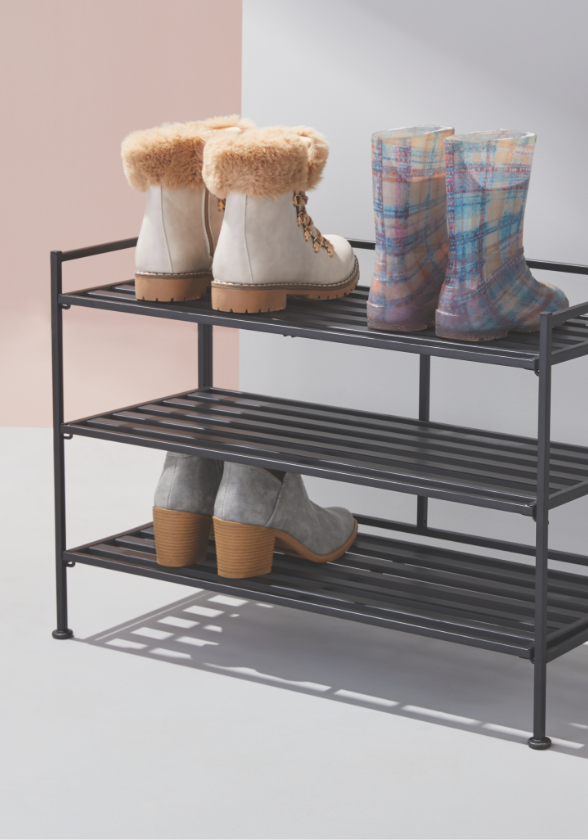 Boots and shoes on a three-tier For Living shoe rack.