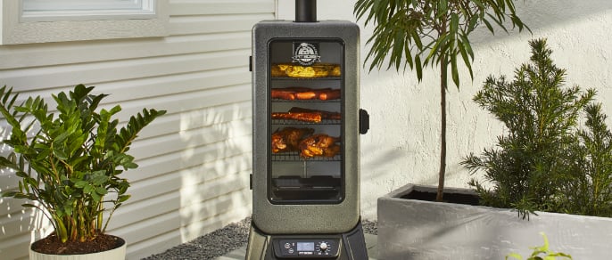 Pit Boss 3-Series Digital Wood Pellet Smoker on patio with meat cooking inside. 