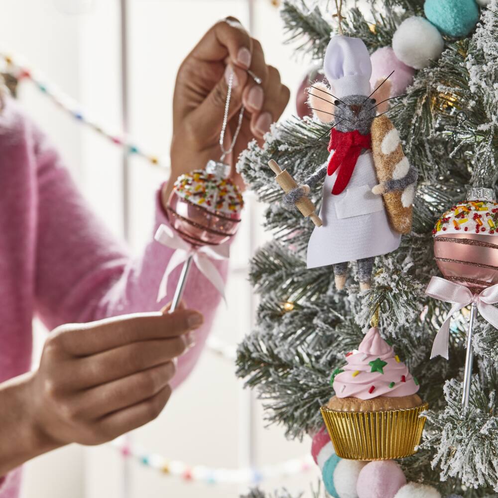 Brights Baker Mouse, Brights Cupcake, and Brights Glass Cake Pop ornaments hanging on a Christmas tree.