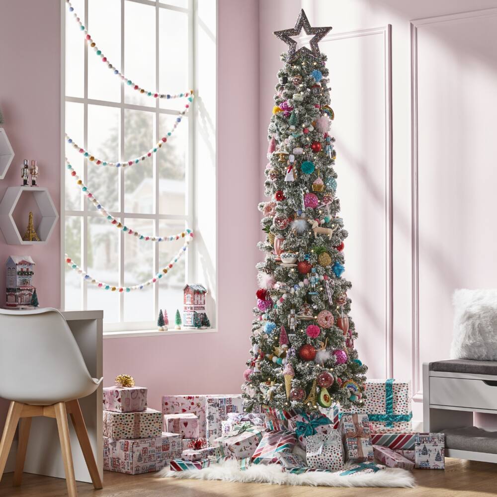 NOMA 7-ft Pre-Lit Bennet Pencil Christmas Tree decorated with colourful ornaments from the Brights Collection.
