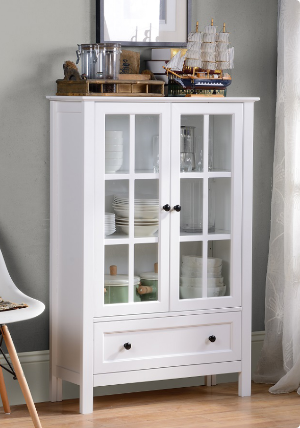 A cabinet with windowpane doors painted bright white.