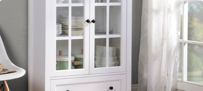 A cabinet with windowpane doors painted bright white.