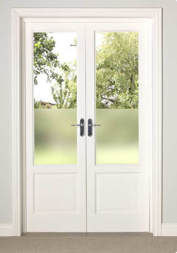 A pair of French doors and doorframe painted white, leading to a yard.