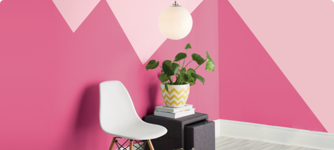 A two-tone wall with zig-zag pattern painted in fuchsia and salmon pink.