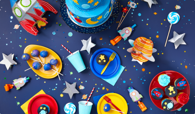 A table with space theme decoration, cake and treats