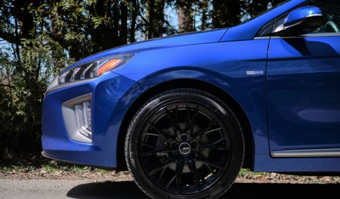 Close up of tires on a blue car. 