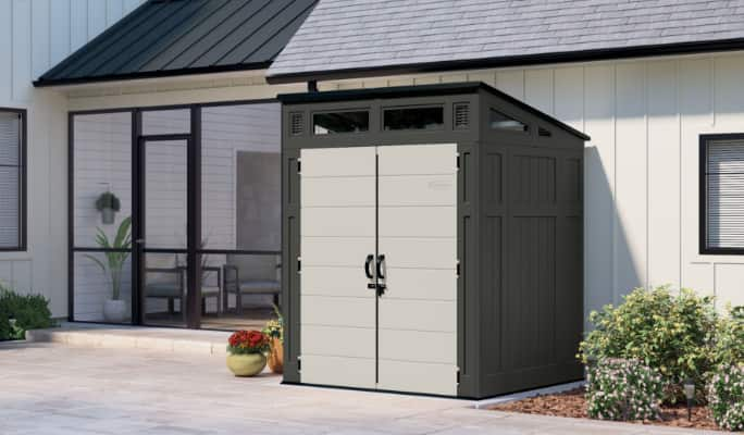 Outdoor shed placed alongside a house. 