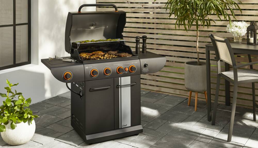 Burgers on MASTER Chef® 4-Burner Grill Turismo Convertible Propane BBQ in backyard. 