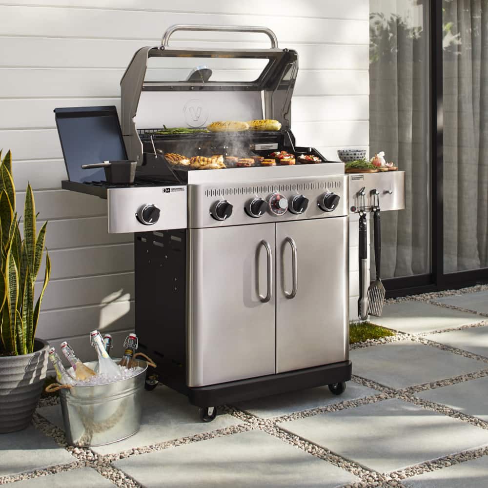 Vida by PADERNO 4-Burner Essence Series Gas BBQ in backyard, grilling corn and chicken.