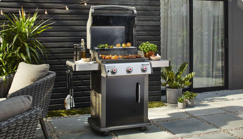 Weber Spirit 3-Burner Propane BBQ in backyard, grilling veggies and meat.