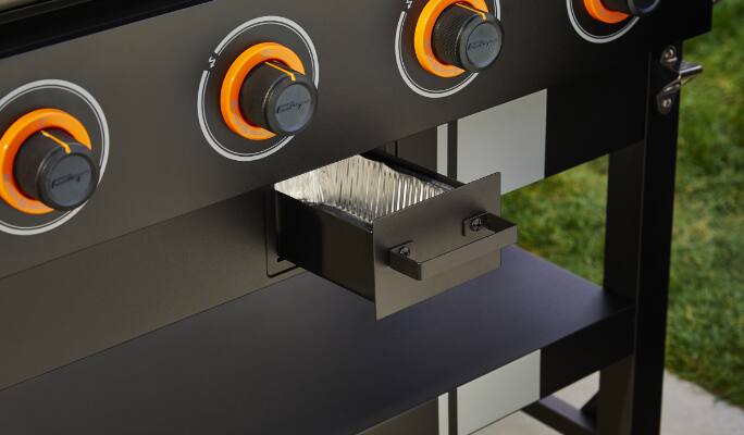 Temperature dials and grease tray on MASTER Chef® Grill Turismo 4-Burner Griddle.