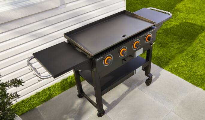 MASTER Chef® Grill Turismo 4-Burner Griddle in backyard. Front access grease tray for easy clean-up.