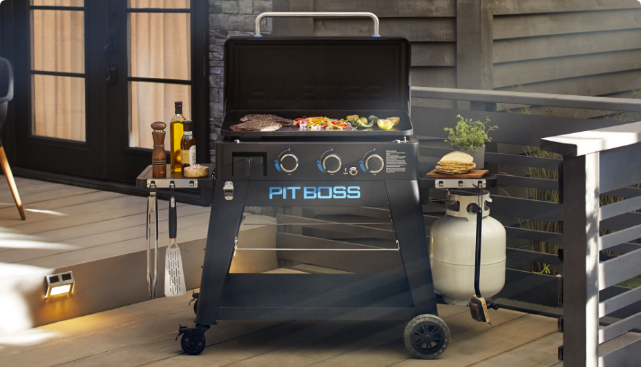 Pit Boss® Ultimate 3-Burner Lift-Off Griddle in backyard grilling meat and veggies. 