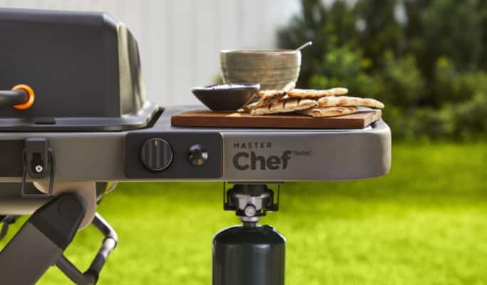 Pita bread and dip on MASTER Chef® Portable BBQ side panels.