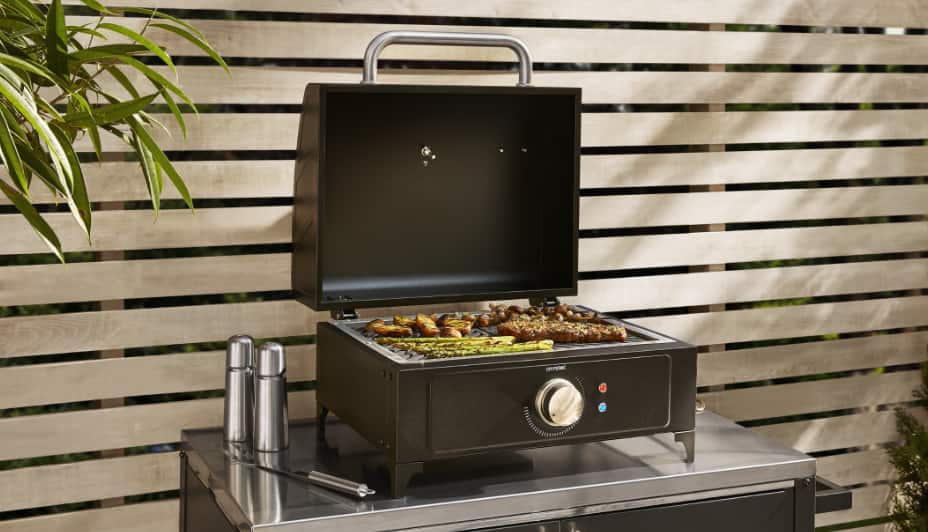 MASTER Chef® Electric Portable BBQ grilling asparagus and meat on patio table.