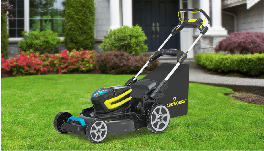 Blue and black cordless lawn mower on grass. 
