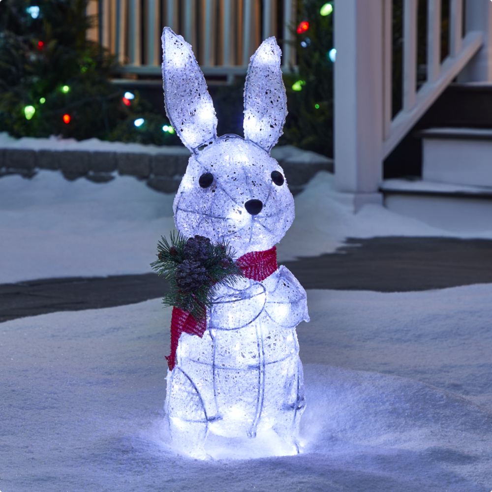 CANVAS 26-inch LED Arctic White Bunny lit up on a snowy lawn.