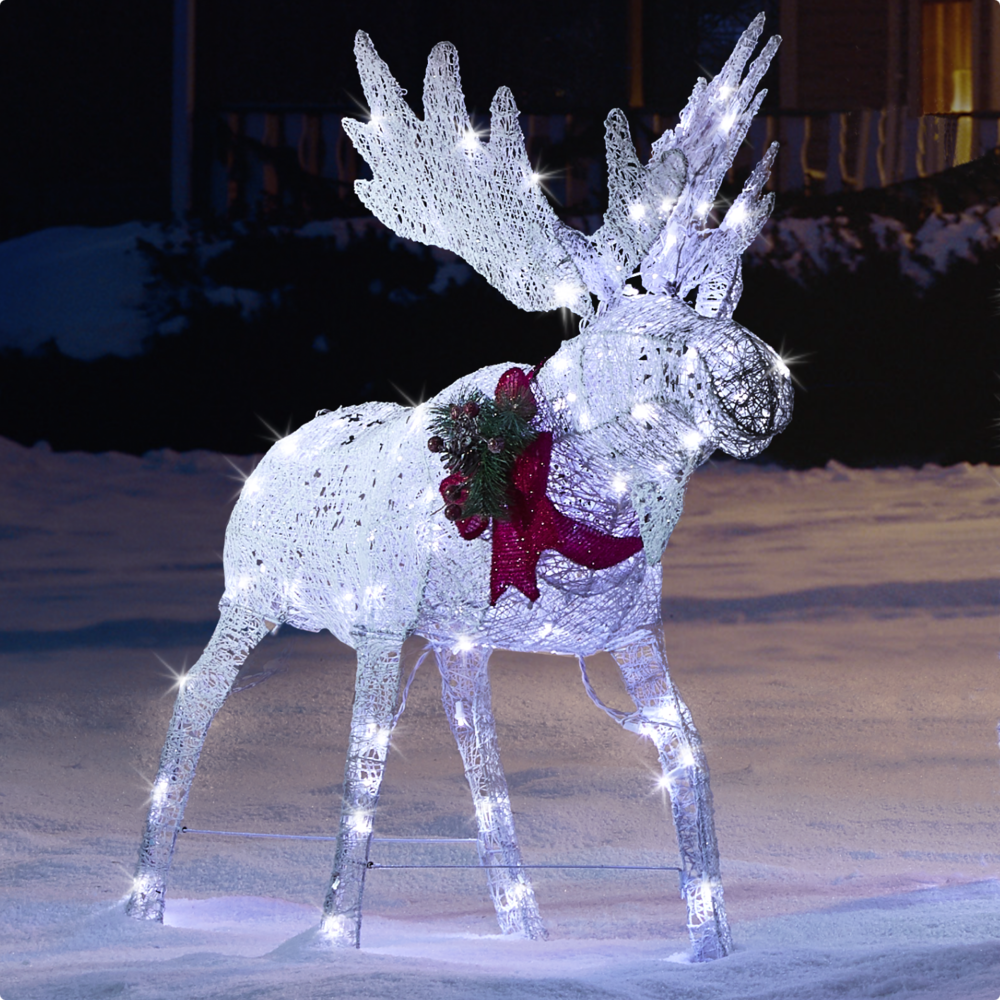 CANVAS 4-ft LED Arctic White Moose lit up on a snowy front lawn.