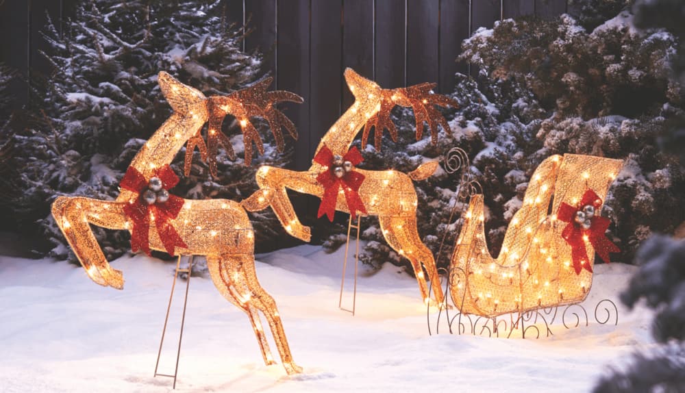 CANVAS LED 4-ft White Deer & Sleigh yard decoration on a front lawn of a house.